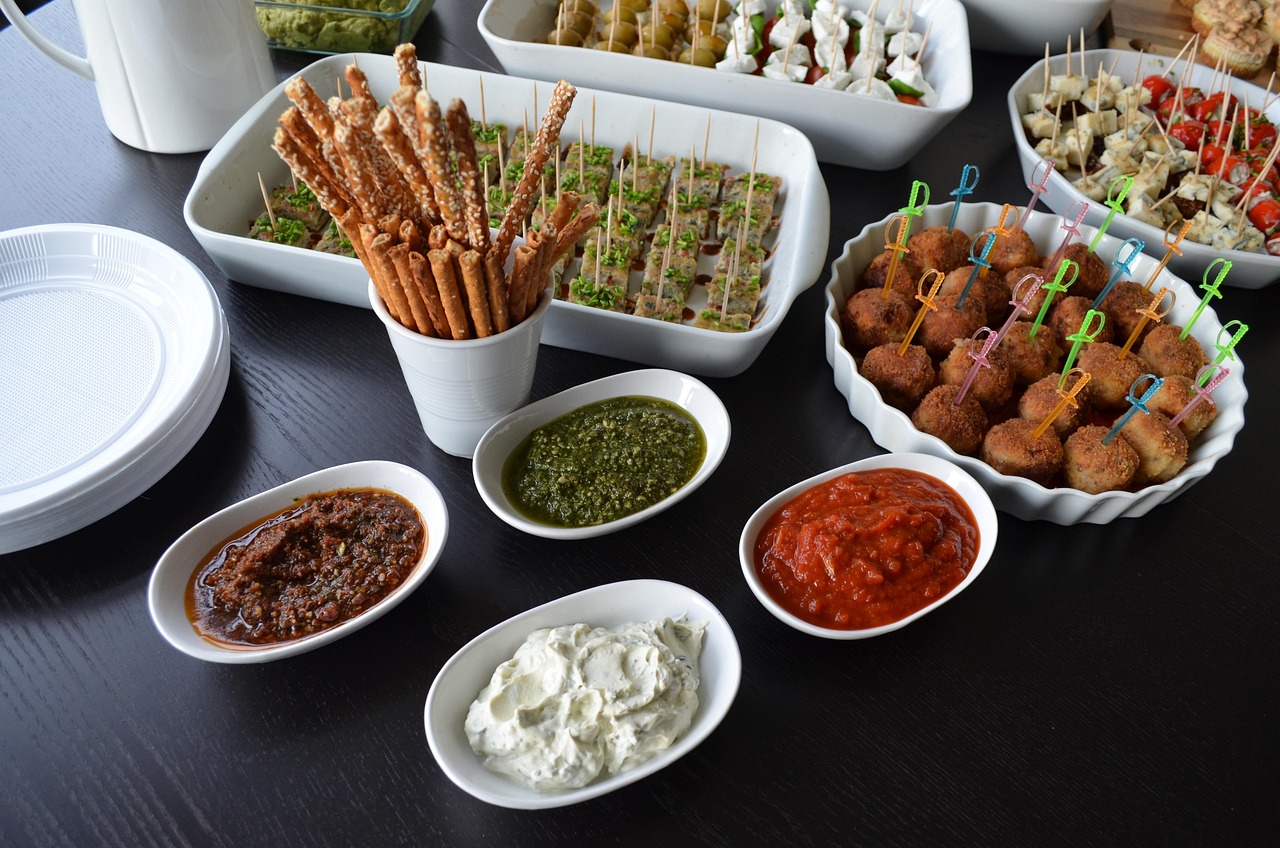 several bowls of food and dips