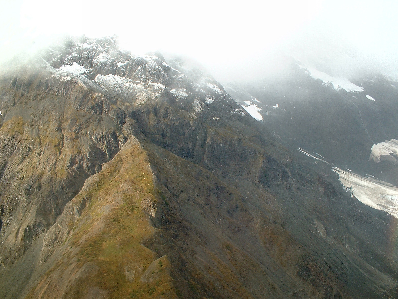 mountain cliffs with mountain goats aerial in alaska 