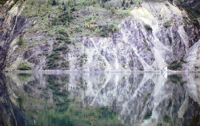 reflection with grey cliff wall in alaska