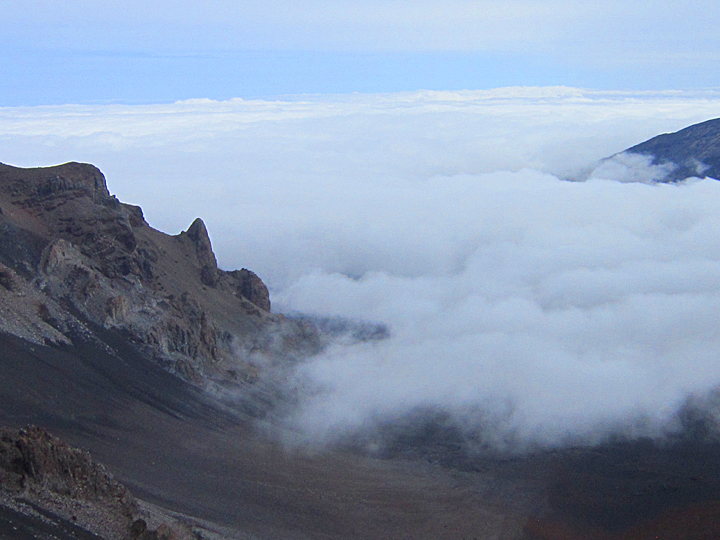 clouds creeping in over mountains at top of haleakala national park