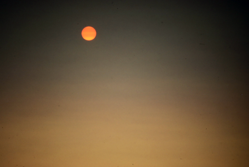 orange sun visible by fire sky