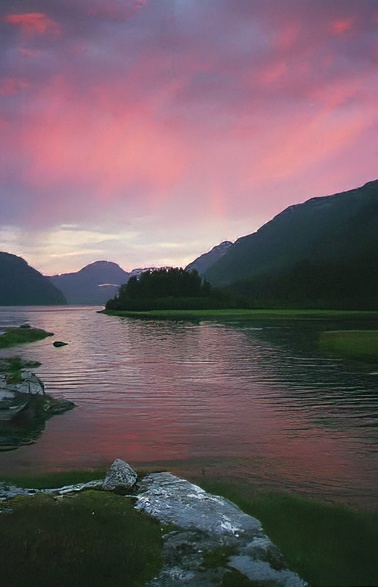 pink sunset with rocky shore water and hills