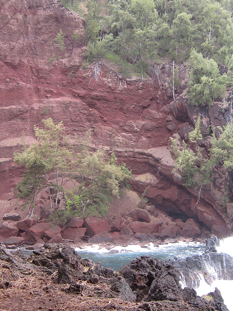 red rock wall and blue water