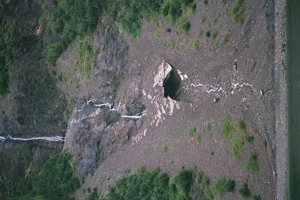 waterfall coming through a couple snow caves 