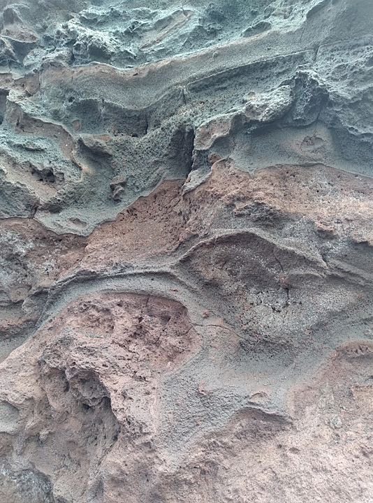 artsy curving silver and pink sand stone formation by Nakalele blowhole on maui