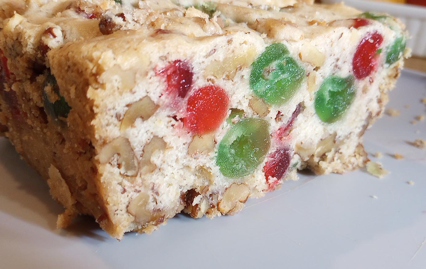 white cake with nuts and green cherries and red cherries